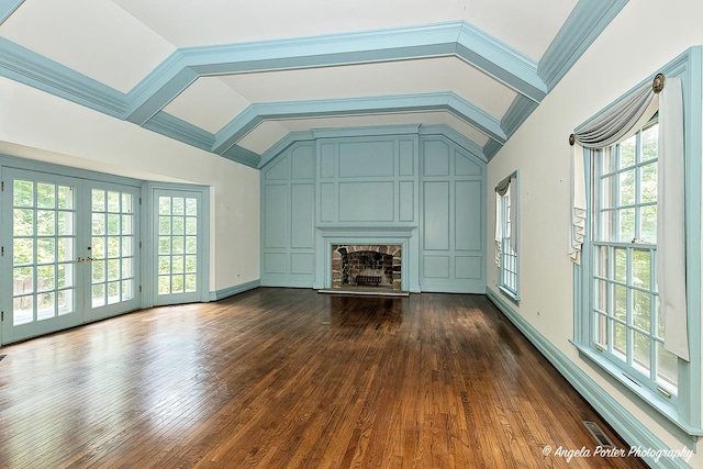 21293 N Andover Rd, Kildeer, IL 60047 - unfurnished living room with lofted ceiling, dark wood-type flooring, a stone fireplace, and french doors