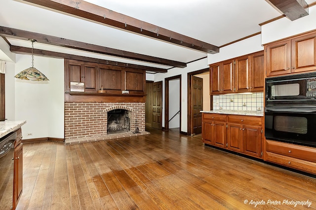 21293 N Andover Rd, Kildeer, IL 60047 - kitchen with black appliances, tasteful backsplash, dark wood-type flooring, beam ceiling, and a brick fireplace