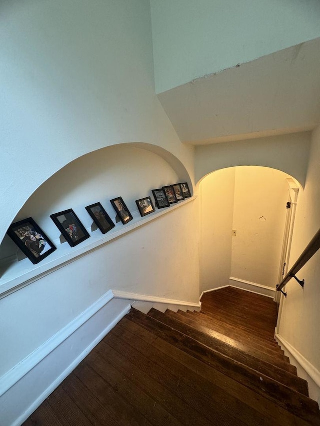 1309 S Main St, Bloomington, IL 61701 - staircase with arched walkways, hardwood / wood-style flooring, and baseboards
