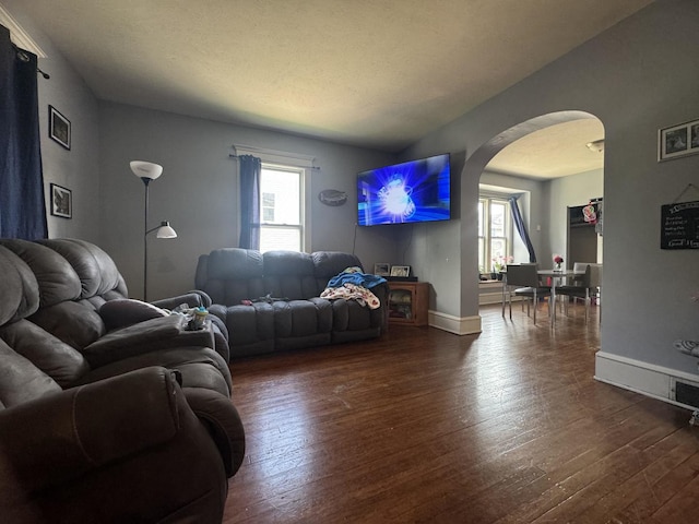 1309 S Main St, Bloomington, IL 61701 - living area with arched walkways, healthy amount of natural light, and dark wood finished floors