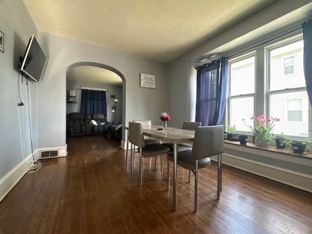 1309 S Main St, Bloomington, IL 61701 - dining space featuring arched walkways, hardwood / wood-style flooring, and baseboards