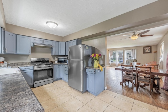 205 Glen St, West Chicago, IL 60185 - kitchen with appliances with stainless steel finishes, under cabinet range hood, light tile patterned floors, ceiling fan, and a sink