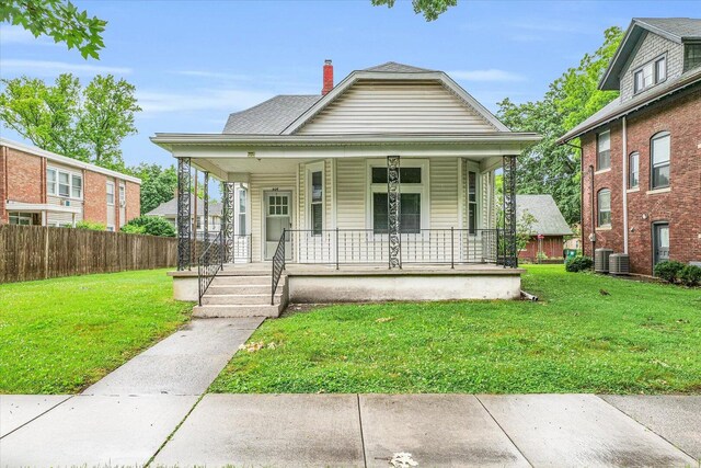 504 W Healey St, Champaign, IL 61820 - bungalow-style house with covered porch, a chimney, and cooling unit