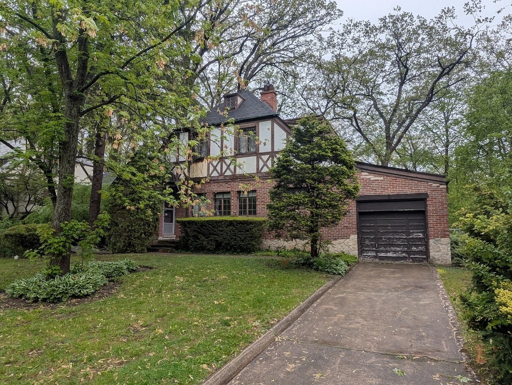 3107 Dato Ave, Highland Park, IL 60035 - view of front of property featuring brick siding, concrete driveway, a chimney, a garage, and a front lawn