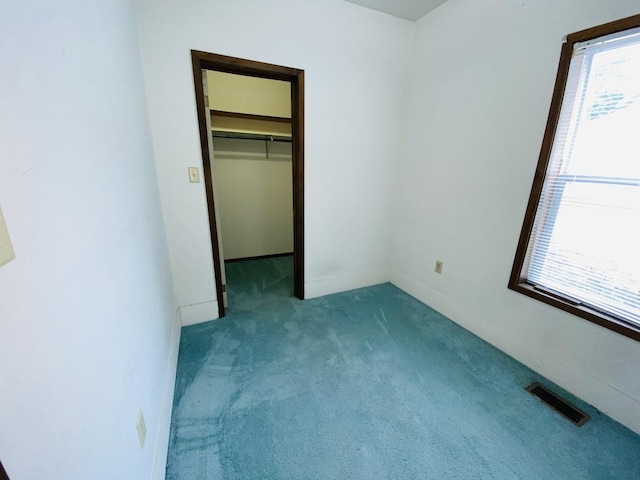 807 W Washington St, Pontiac, IL 61764 - unfurnished bedroom featuring carpet flooring, a walk in closet, and a closet