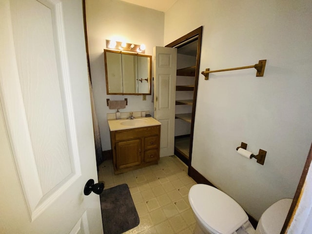 807 W Washington St, Pontiac, IL 61764 - bathroom with toilet, vanity, and baseboards