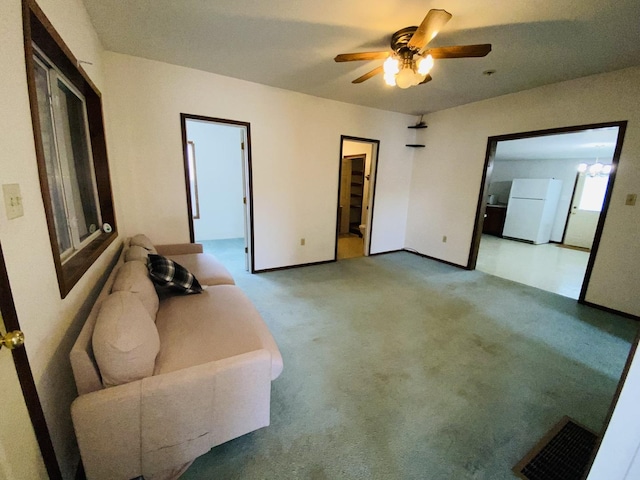807 W Washington St, Pontiac, IL 61764 - unfurnished living room featuring a ceiling fan, carpet flooring, and baseboards