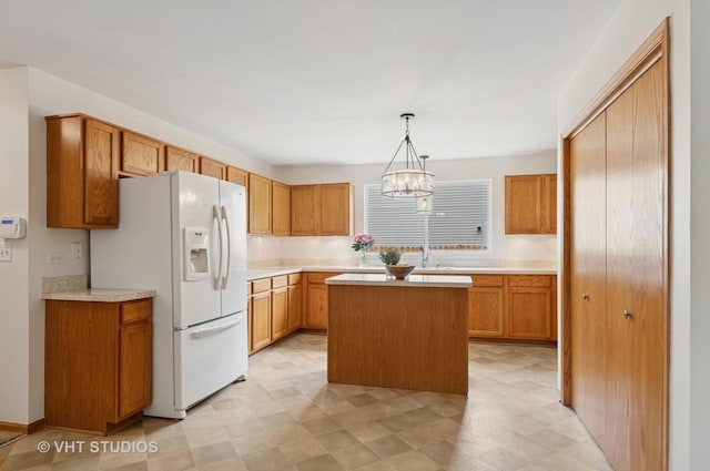 5203 Brighton Ln, Plainfield, IL 60586 - kitchen featuring white refrigerator with ice dispenser, light countertops, a kitchen island, and hanging light fixtures