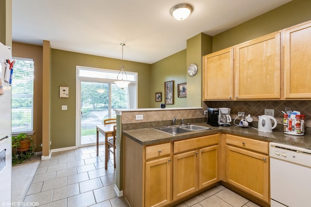 1532 Legacy Dr Unit 3, Dekalb, IL 60115 - kitchen with white dishwasher, a sink, a peninsula, tasteful backsplash, and dark countertops
