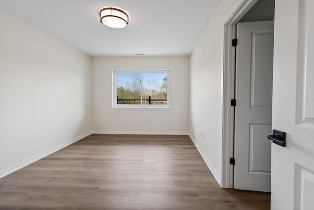 2034 W 75th Pl Unit 32, Merrillville, IN 46410 - spare room with wood finished floors and baseboards