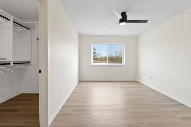 2034 W 75th Pl Unit 32, Merrillville, IN 46410 - unfurnished bedroom featuring wood finished floors, baseboards, and ceiling fan