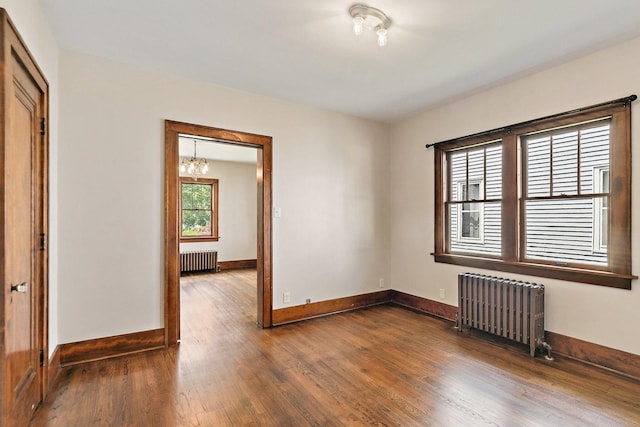 610 S 3rd St, Dekalb, IL 60115 - unfurnished room with radiator heating unit, a chandelier, and wood finished floors