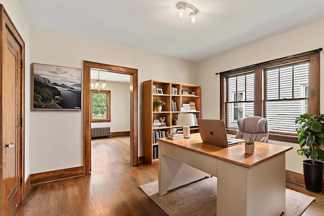 610 S 3rd St, Dekalb, IL 60115 - office featuring radiator heating unit, wood finished floors, and a chandelier