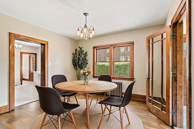 610 S 3rd St, Dekalb, IL 60115 - dining room with a chandelier, light wood finished floors, and radiator heating unit