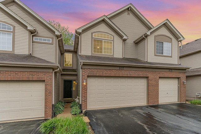 977 Parkhill Cir, Aurora, IL 60502 - view of front of home featuring driveway, brick siding, and an attached garage