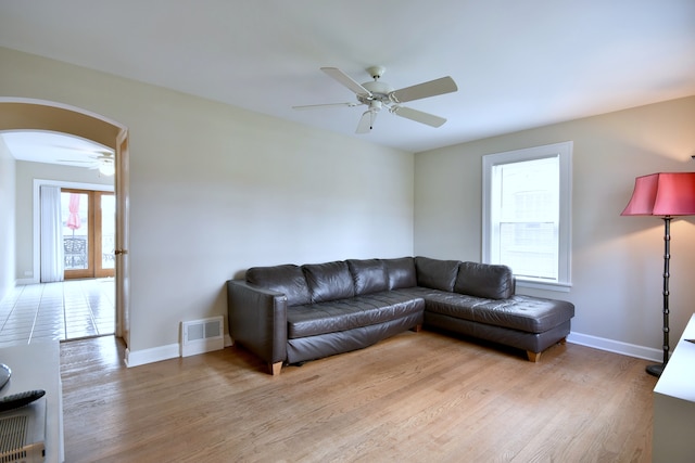 1625 N 73rd Ct, Elmwood Park, IL 60707 - living area with ceiling fan, arched walkways, light wood-style floors, and baseboards