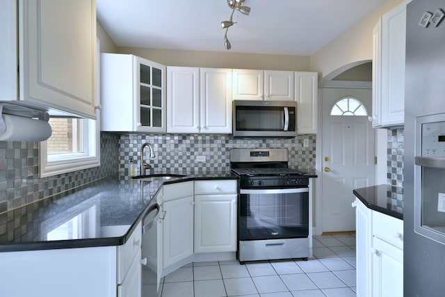 1625 N 73rd Ct, Elmwood Park, IL 60707 - kitchen with appliances with stainless steel finishes, a sink, white cabinets, and healthy amount of natural light