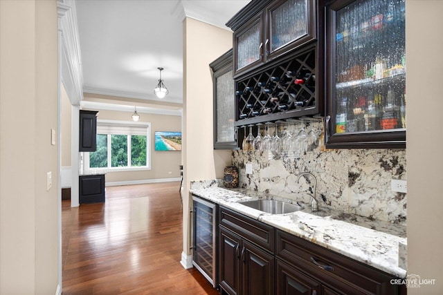 4748 Sassafras Ln, Naperville, IL 60564 - indoor wet bar featuring beverage cooler, crown molding, decorative backsplash, wood finished floors, and baseboards