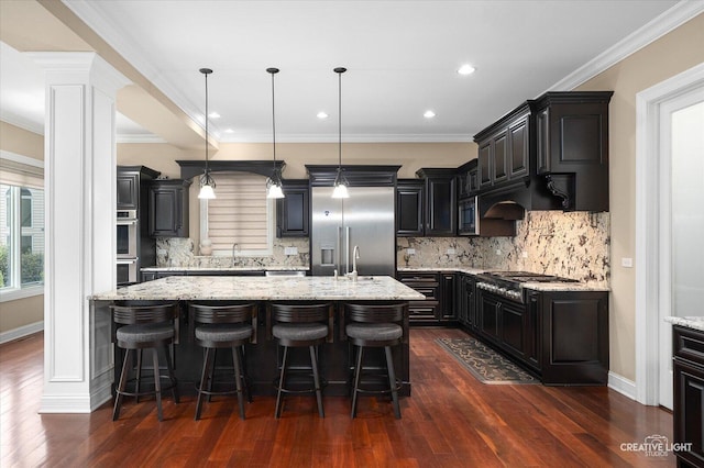 4748 Sassafras Ln, Naperville, IL 60564 - kitchen with stainless steel appliances, dark wood-type flooring, a center island with sink, a sink, and light stone counters