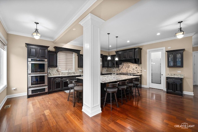 4748 Sassafras Ln, Naperville, IL 60564 - kitchen with appliances with stainless steel finishes, a sink, wood finished floors, decorative backsplash, and ornamental molding