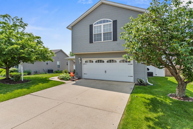 3807 Sandstone Dr, Champaign, IL 61822 - view of front of house featuring a garage, a front yard, driveway, and central AC unit