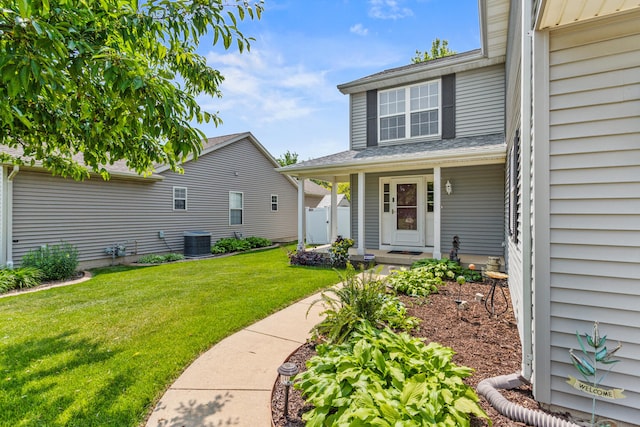 3807 Sandstone Dr, Champaign, IL 61822 - property entrance featuring central air condition unit, a yard, and covered porch