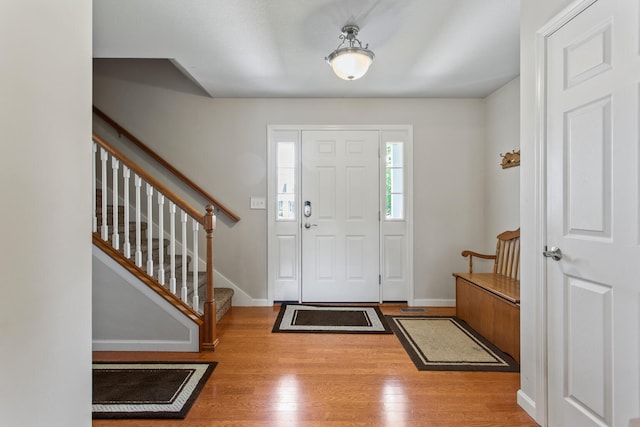 3807 Sandstone Dr, Champaign, IL 61822 - entryway featuring wood finished floors, baseboards, and stairway