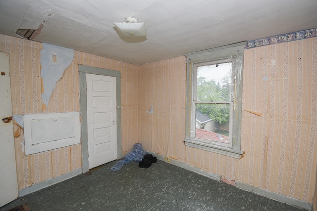 937 N County St, Waukegan, IL 60085 - unfurnished room with wallpapered walls and baseboards