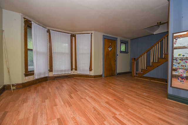 937 N County St, Waukegan, IL 60085 - unfurnished living room with wood finished floors, stairs, and baseboards