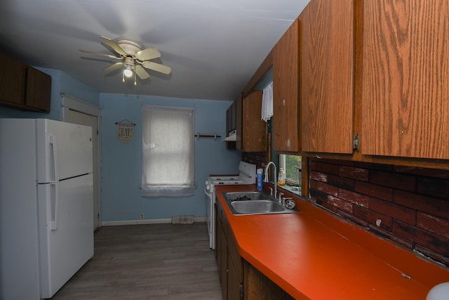 937 N County St, Waukegan, IL 60085 - kitchen with white appliances, a ceiling fan, a sink, and brown cabinets