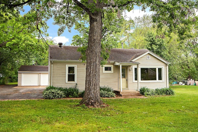21402 S 79th Ave, Frankfort, IL 60423 - view of front of house featuring a detached garage, a front lawn, an outbuilding, and a shingled roof
