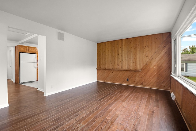 21402 S 79th Ave, Frankfort, IL 60423 - spare room with wooden walls, dark wood-type flooring, and baseboards