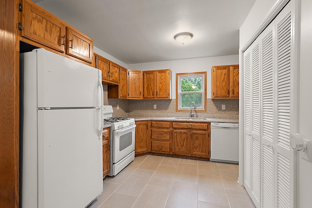 21402 S 79th Ave, Frankfort, IL 60423 - kitchen with white appliances, a sink, tasteful backsplash, brown cabinets, and light countertops