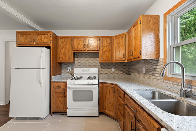 21402 S 79th Ave, Frankfort, IL 60423 - kitchen with white appliances, a sink, light tile patterned floors, brown cabinetry, and tasteful backsplash