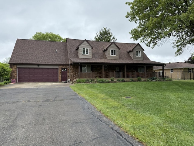 39 S Pickett Dr, Fisher, IL 61843 - view of front of home featuring asphalt driveway, an attached garage, covered porch, a shingled roof, and brick siding