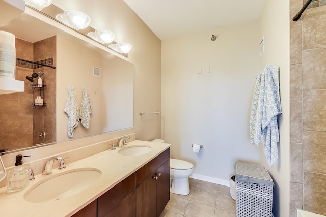 757 N Orleans St Unit 909, Chicago, IL 60654 - full bath with double vanity, toilet, tiled shower, and tile patterned flooring