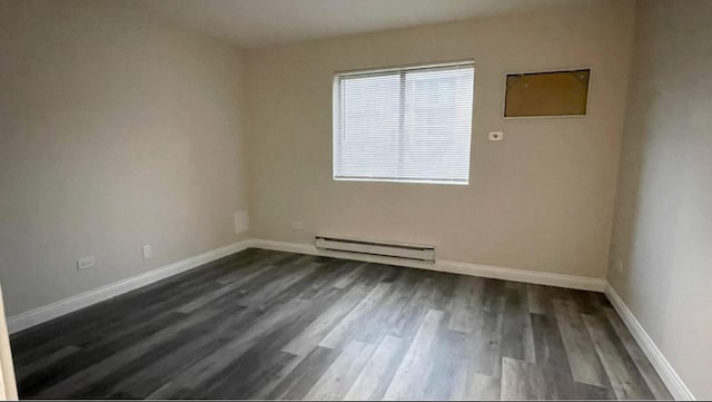 633 Virginia Rd Unit 116, Crystal Lake, IL 60014 - unfurnished room featuring a baseboard radiator, dark wood-style flooring, and baseboards