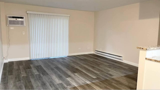 633 Virginia Rd Unit 116, Crystal Lake, IL 60014 - spare room with baseboard heating, a wall mounted air conditioner, dark wood-style flooring, and baseboards