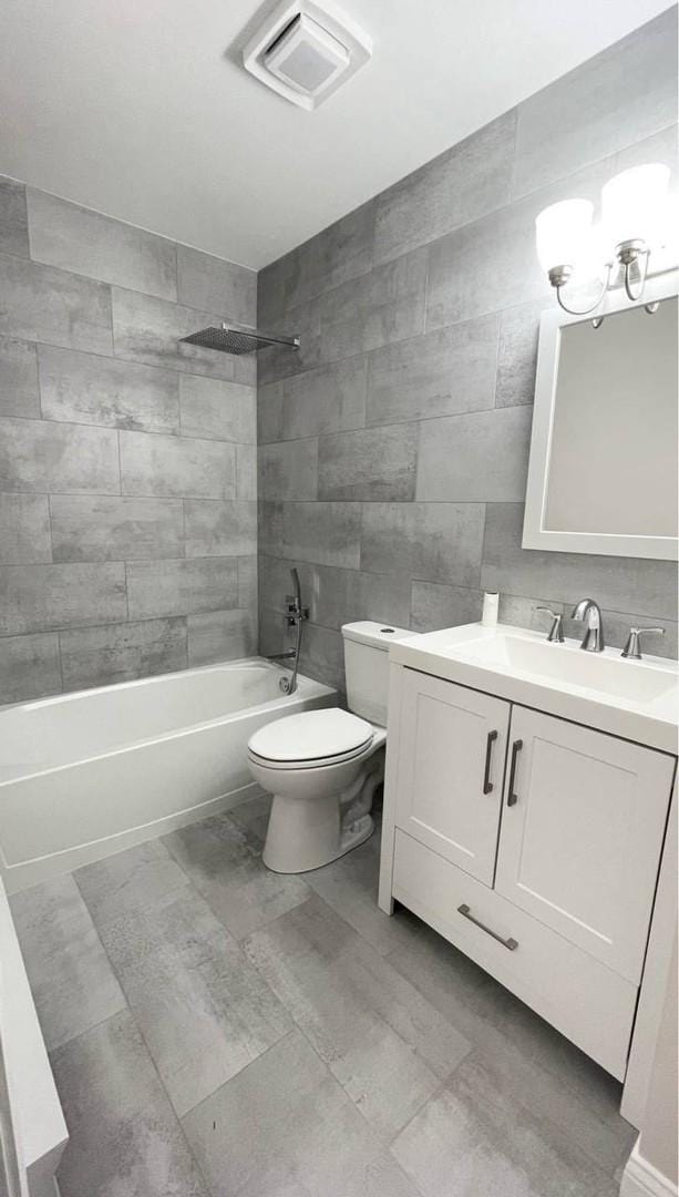 633 Virginia Rd Unit 116, Crystal Lake, IL 60014 - full bathroom with toilet, shower / bath combination, vanity, and tile walls