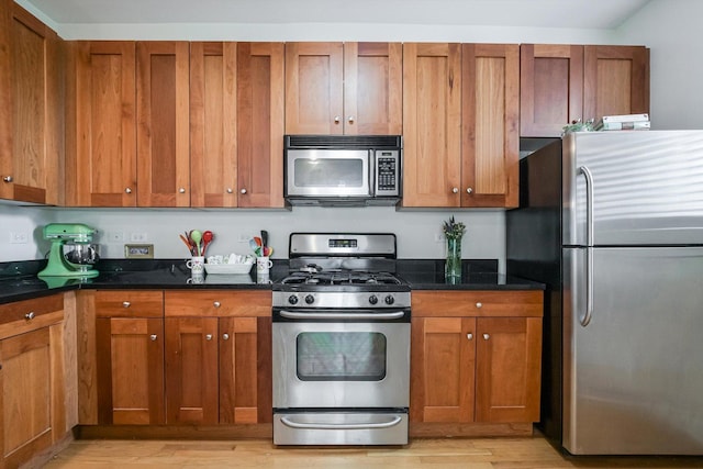 626 Judson Ave Unit 3, Evanston, IL 60202 - kitchen with stainless steel appliances, light wood-style flooring, and brown cabinets