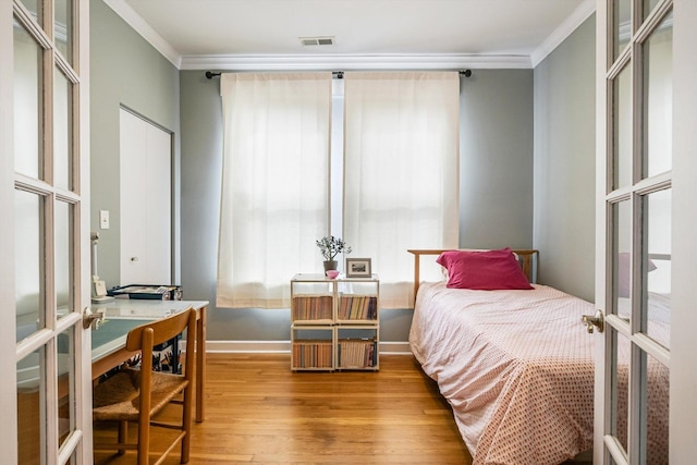 626 Judson Ave Unit 3, Evanston, IL 60202 - bedroom with crown molding, wood finished floors, french doors, and baseboards
