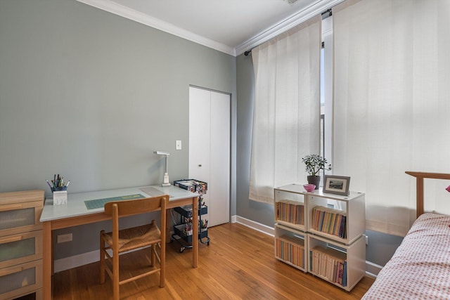 626 Judson Ave Unit 3, Evanston, IL 60202 - bedroom featuring wood finished floors, crown molding, an office area, and baseboards