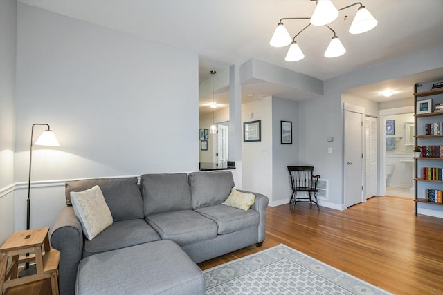 626 Judson Ave Unit 3, Evanston, IL 60202 - living area featuring wood finished floors, a chandelier, and baseboards