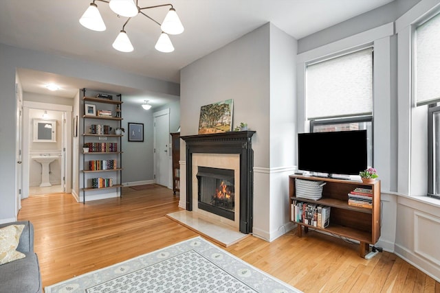 626 Judson Ave Unit 3, Evanston, IL 60202 - living room with a warm lit fireplace, wood finished floors, and a chandelier