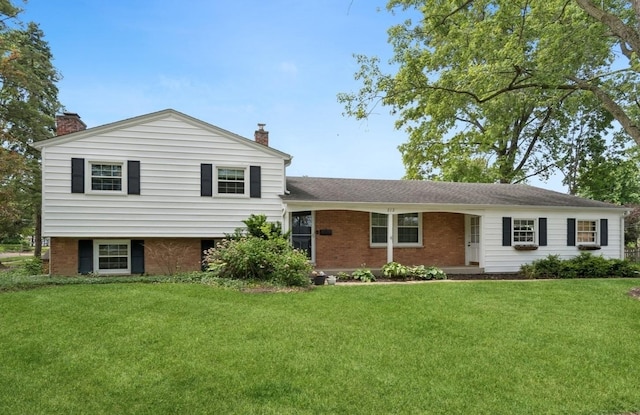212 E 11th Ave, Naperville, IL 60563 - tri-level home with a chimney, a front yard, and brick siding