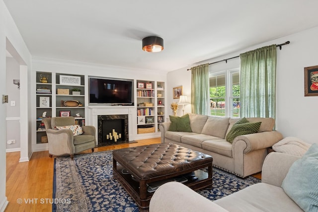 212 E 11th Ave, Naperville, IL 60563 - living area featuring built in features, a fireplace, light wood-style floors, and baseboards