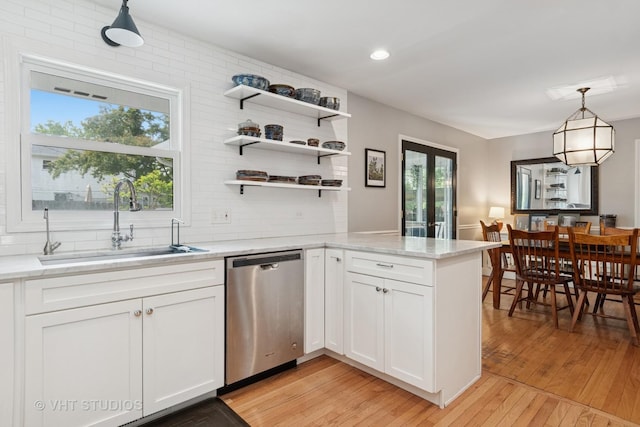 212 E 11th Ave, Naperville, IL 60563 - kitchen with dishwasher, a sink, white cabinetry, light wood-style floors, and a peninsula