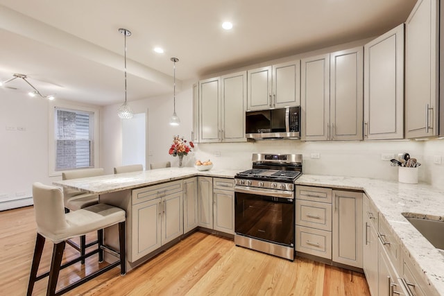 5319 W Cullom Ave, Chicago, IL 60641 - kitchen with stainless steel appliances, a peninsula, light wood-type flooring, light stone countertops, and recessed lighting
