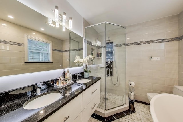 5319 W Cullom Ave, Chicago, IL 60641 - bathroom featuring a stall shower, toilet, double vanity, and tile walls