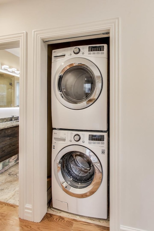 5319 W Cullom Ave, Chicago, IL 60641 - washroom with stacked washer / dryer and light wood-type flooring
